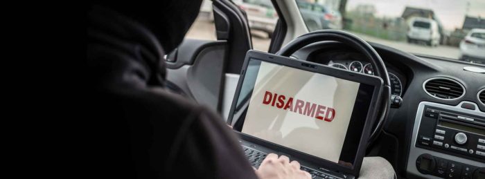Thief using laptop to disarm car